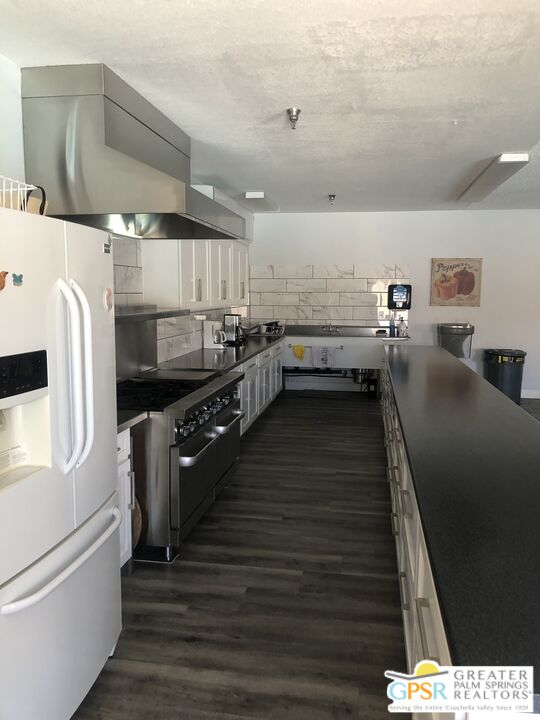 69525 Dillon Road, Unit 73 Desert Hot Springs, CA 92241 - Photo 38 of 48 a kitchen with stainless steel appliances a refrigerator a sink dishwasher stove and oven