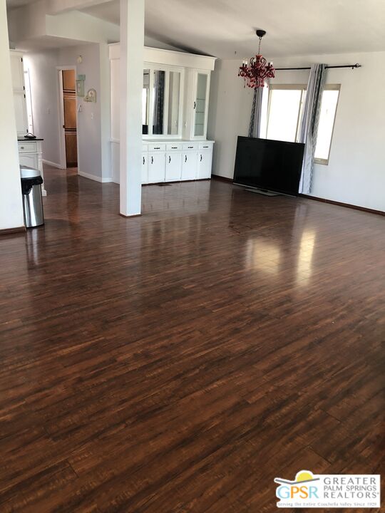 69525 Dillon Road, Unit 73 Desert Hot Springs, CA 92241 - Photo 40 of 48 a view of a living room with hardwood floor and a kitchen view