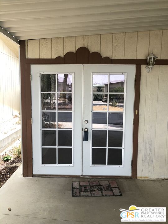 69525 Dillon Road, Unit 73 Desert Hot Springs, CA 92241 - Photo 4 of 48 a front view of a house with a yard
