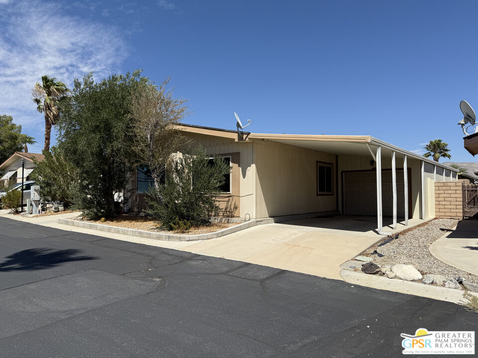 69525 Dillon Road, Unit 73 Desert Hot Springs, CA 92241 - Photo 46 of 48 a backyard of a house with shaded area