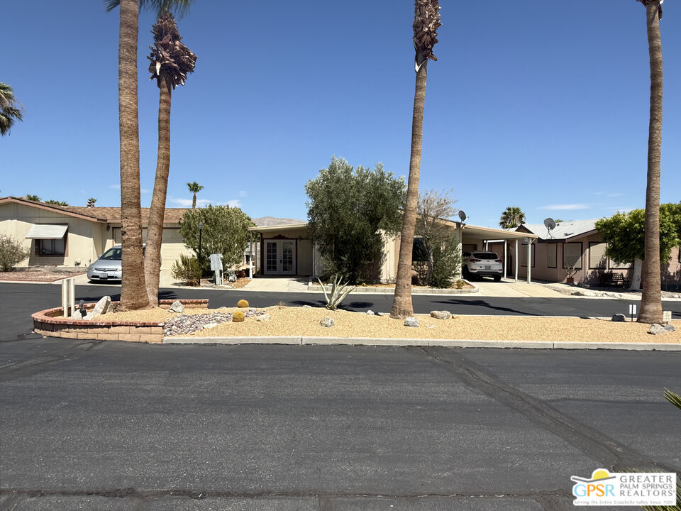 69525 Dillon Road, Unit 73 Desert Hot Springs, CA 92241 - Photo 48 of 48 a view of a swimming pool with a lawn chairs