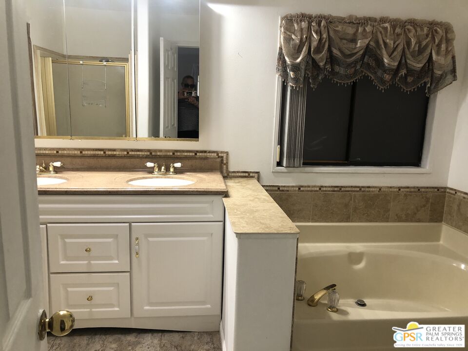 69525 Dillon Road, Unit 73 Desert Hot Springs, CA 92241 - Photo 9 of 48 a bathroom with a sink and a mirror