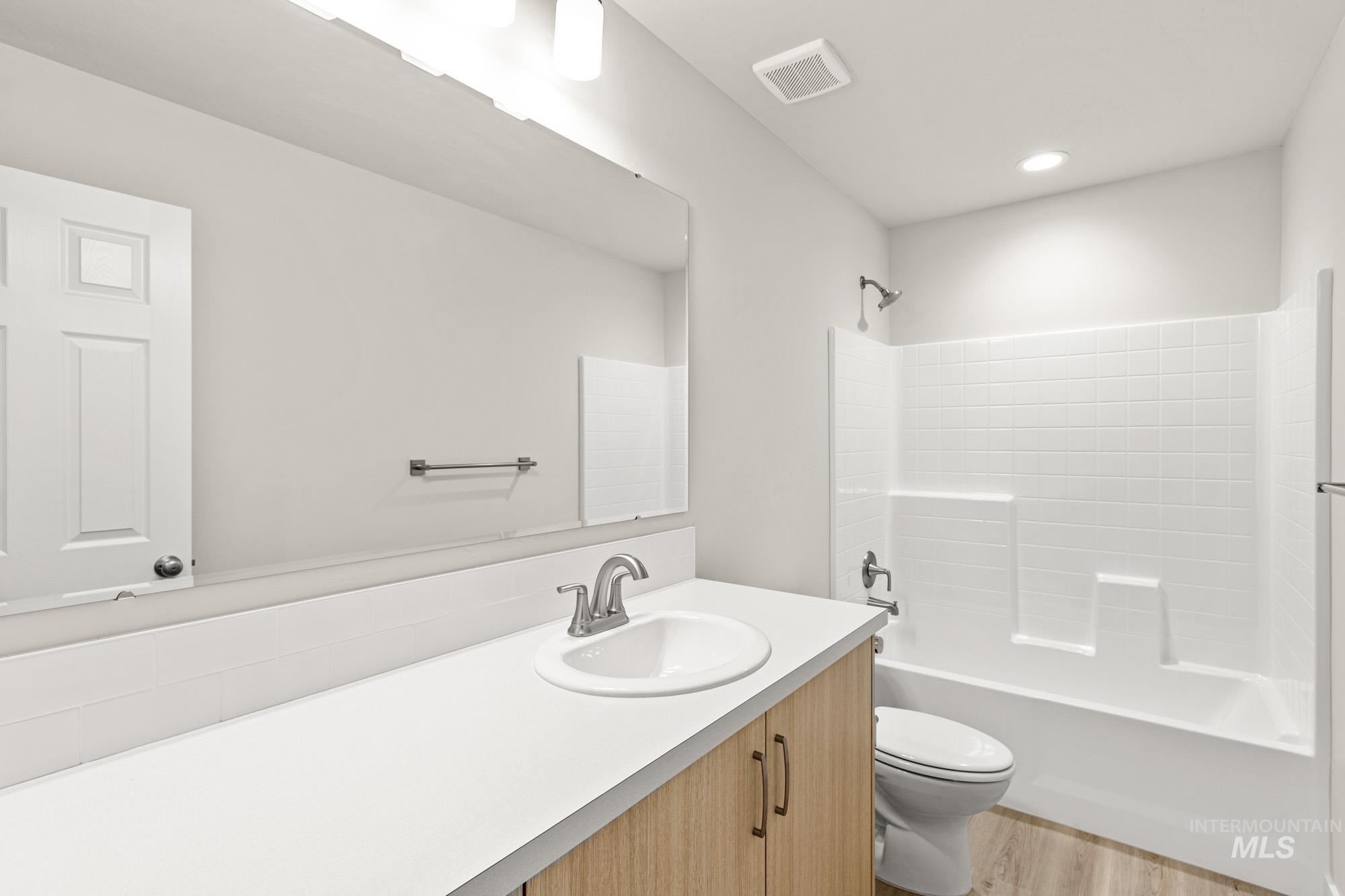 13711 Inman Court Caldwell, ID 83607 - Photo 11 of 16 Full bathroom with vanity, shower / bath combination, and light wood-type flooring