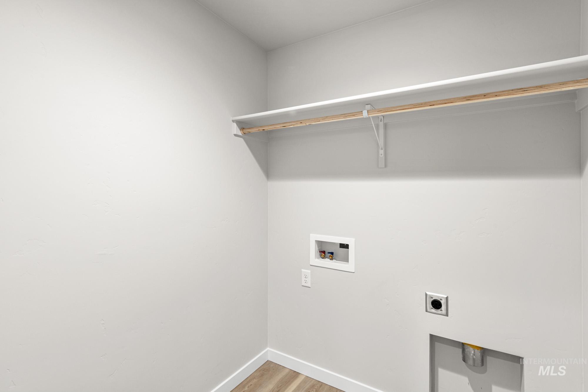 13711 Inman Court Caldwell, ID 83607 - Photo 12 of 16 Laundry area with light wood finished floors, hookup for an electric dryer, and washer hookup