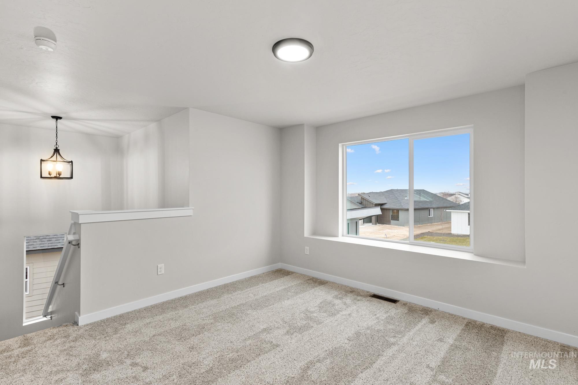 13711 Inman Court Caldwell, ID 83607 - Photo 13 of 16 Unfurnished room with light colored carpet and baseboards