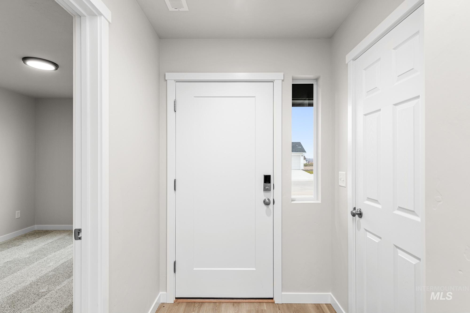 13711 Inman Court Caldwell, ID 83607 - Photo 2 of 16 Doorway with baseboards and wood finished floors