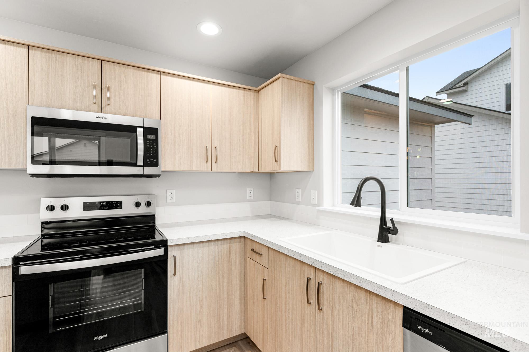 13711 Inman Court Caldwell, ID 83607 - Photo 5 of 16 Kitchen with light wood finish cabinets, stainless steel appliances, light countertops, and recessed lighting
