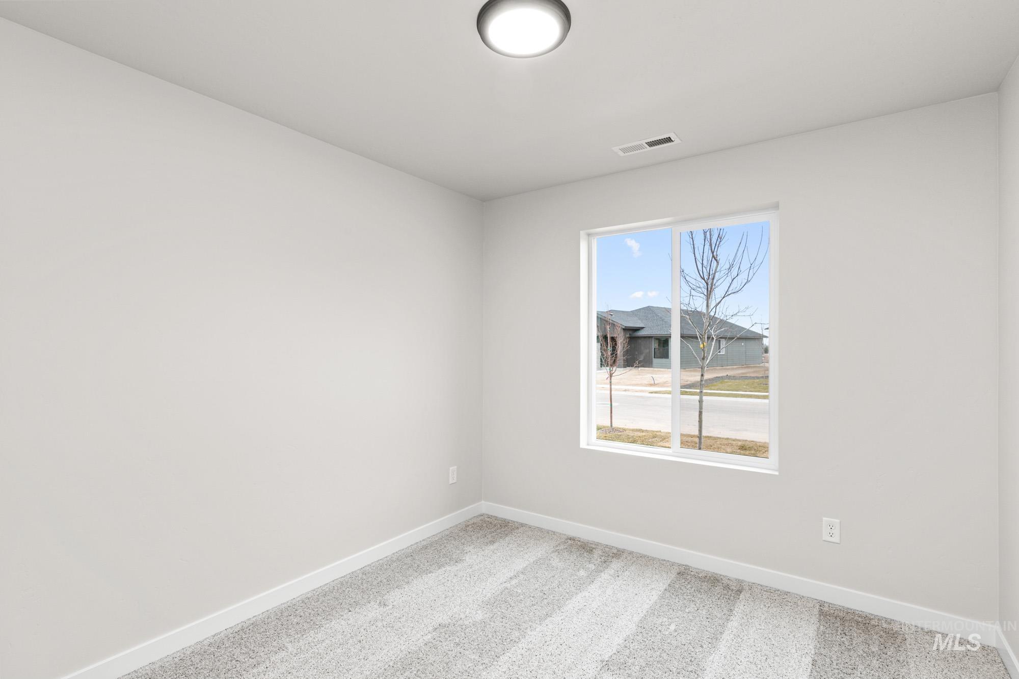 13711 Inman Court Caldwell, ID 83607 - Photo 8 of 16 Spare room featuring carpet floors and baseboards