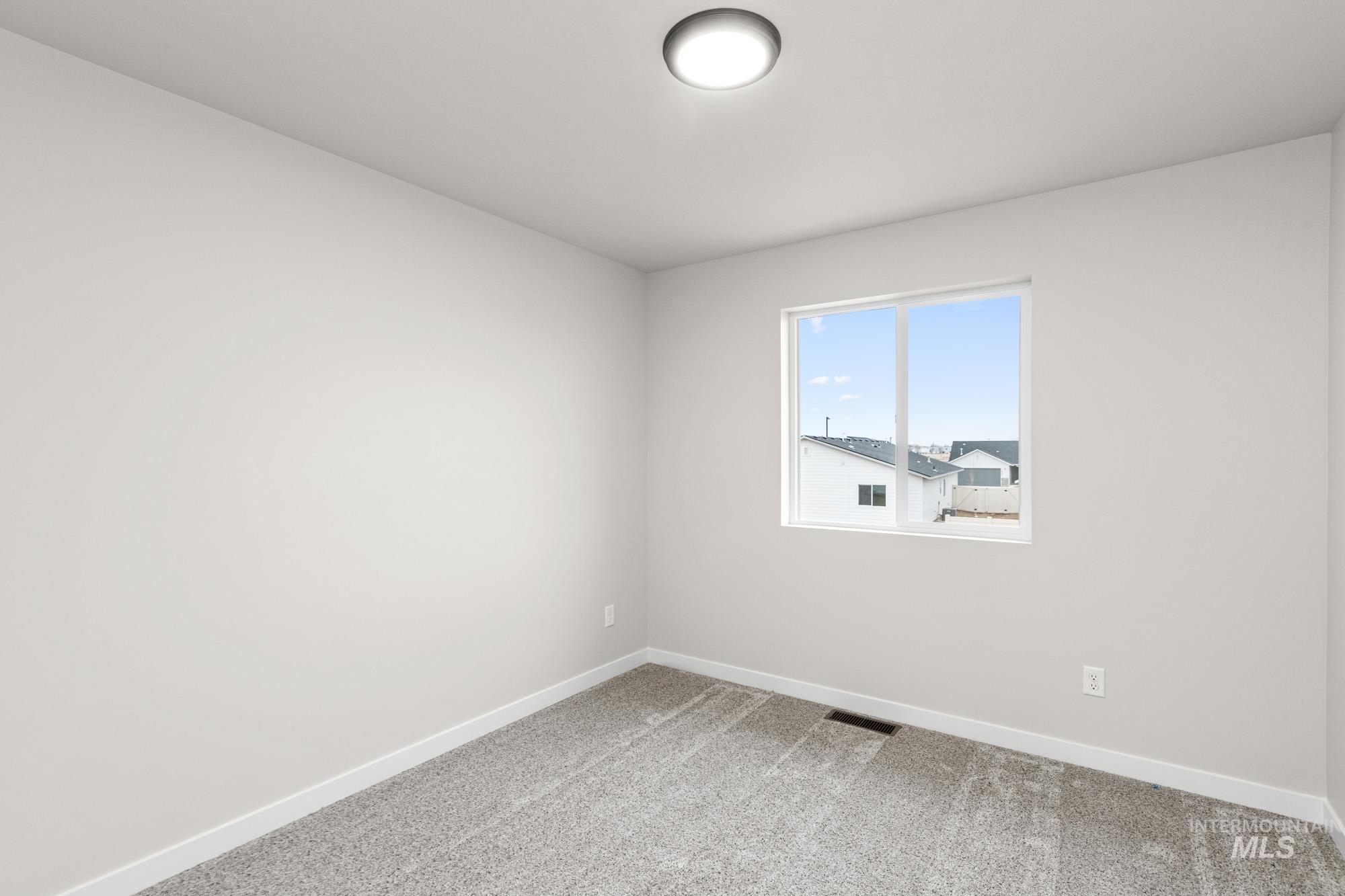 13711 Inman Court Caldwell, ID 83607 - Photo 10 of 16 Unfurnished room featuring carpet and baseboards