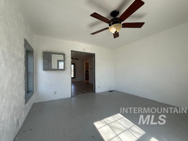 902 East Main Street Weiser, ID 83672 - Photo 23 of 45 Empty room featuring ceiling fan and wood finished floors