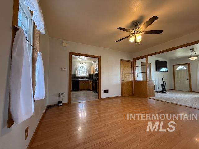 902 East Main Street Weiser, ID 83672 - Photo 3 of 45 Unfurnished living room featuring a ceiling fan and light wood-style flooring