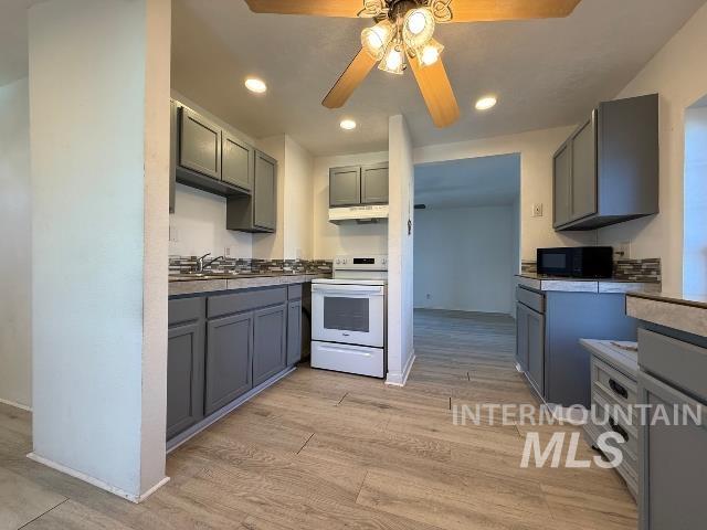 902 East Main Street Weiser, ID 83672 - Photo 9 of 45 Kitchen featuring gray cabinets, ceiling fan, white range with electric cooktop, and recessed lighting
