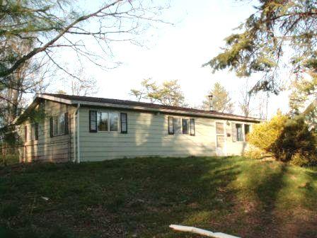 1559 Bush Road Cresco, PA 18326 - Photo 1 of 9 a front view of a house with garden
