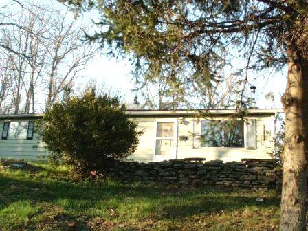 1559 Bush Road Cresco, PA 18326 - Photo 2 of 9 a front view of a house with a garden