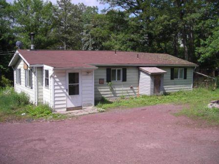1559 Bush Road Cresco, PA 18326 - Photo 3 of 9 a front view of a house with garden