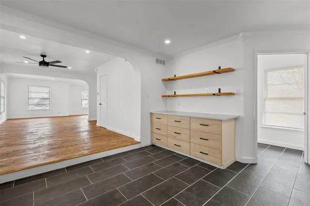 a view of empty room with wooden floor and fireplace