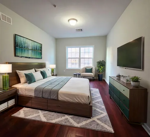 a bedroom with a bed and a flat screen tv