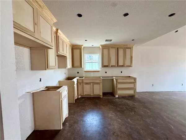a kitchen with a sink cabinets and window