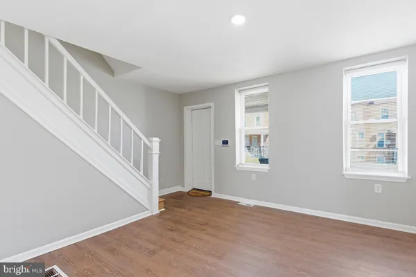 a view of an entryway with wooden floor