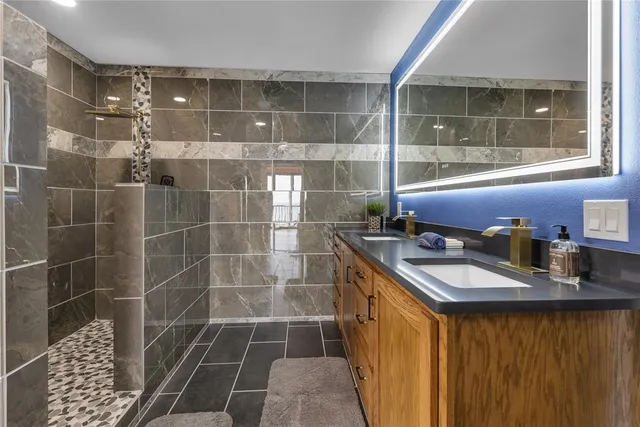 a kitchen with granite countertop a sink and cabinets