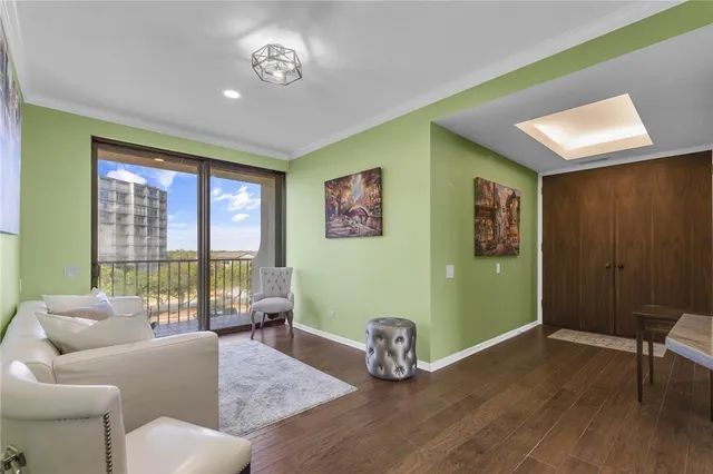 a view of a hallway with wooden floor and furniture