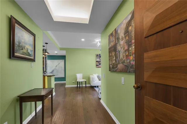 a living room with furniture and painting on the wall