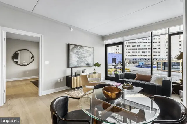 a living room with furniture and a floor to ceiling window