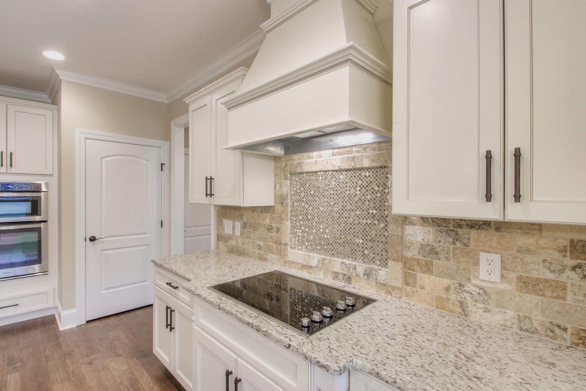 2305 Cairo Bend Road Lebanon, TN 37087 - Photo 11 of 30 a kitchen with granite countertop a sink stainless steel appliances and cabinets