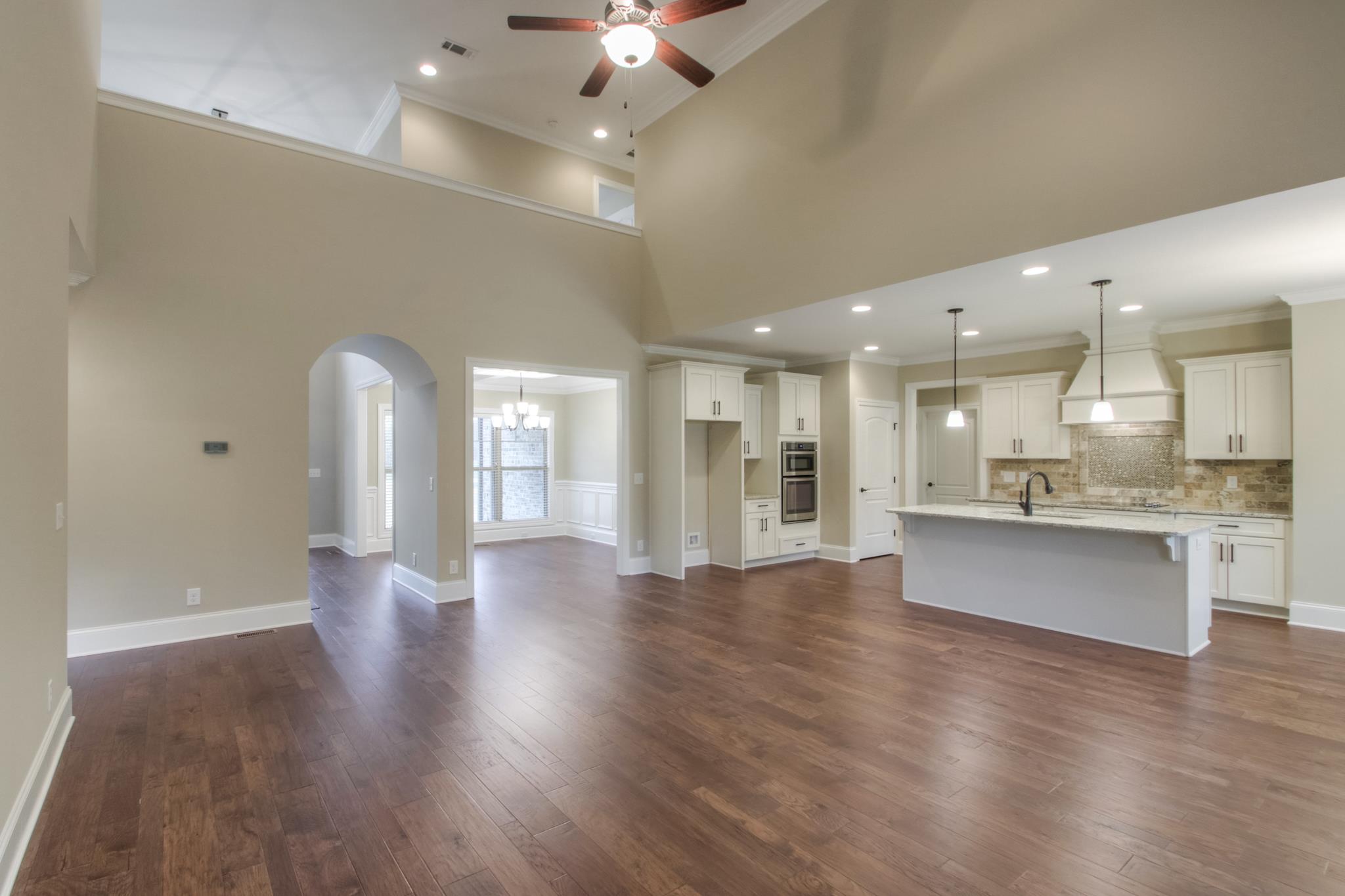 2305 Cairo Bend Road Lebanon, TN 37087 - Photo 13 of 30 a view of an empty room and kitchen with wooden floor
