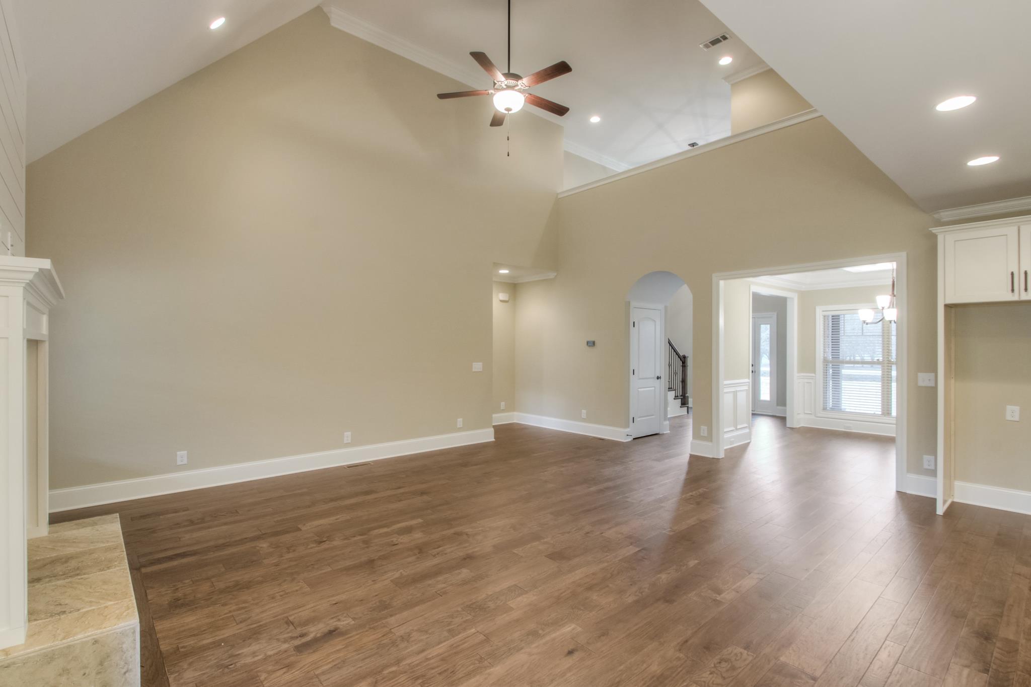2305 Cairo Bend Road Lebanon, TN 37087 - Photo 15 of 30 an empty room with wooden floor ceiling fan and windows