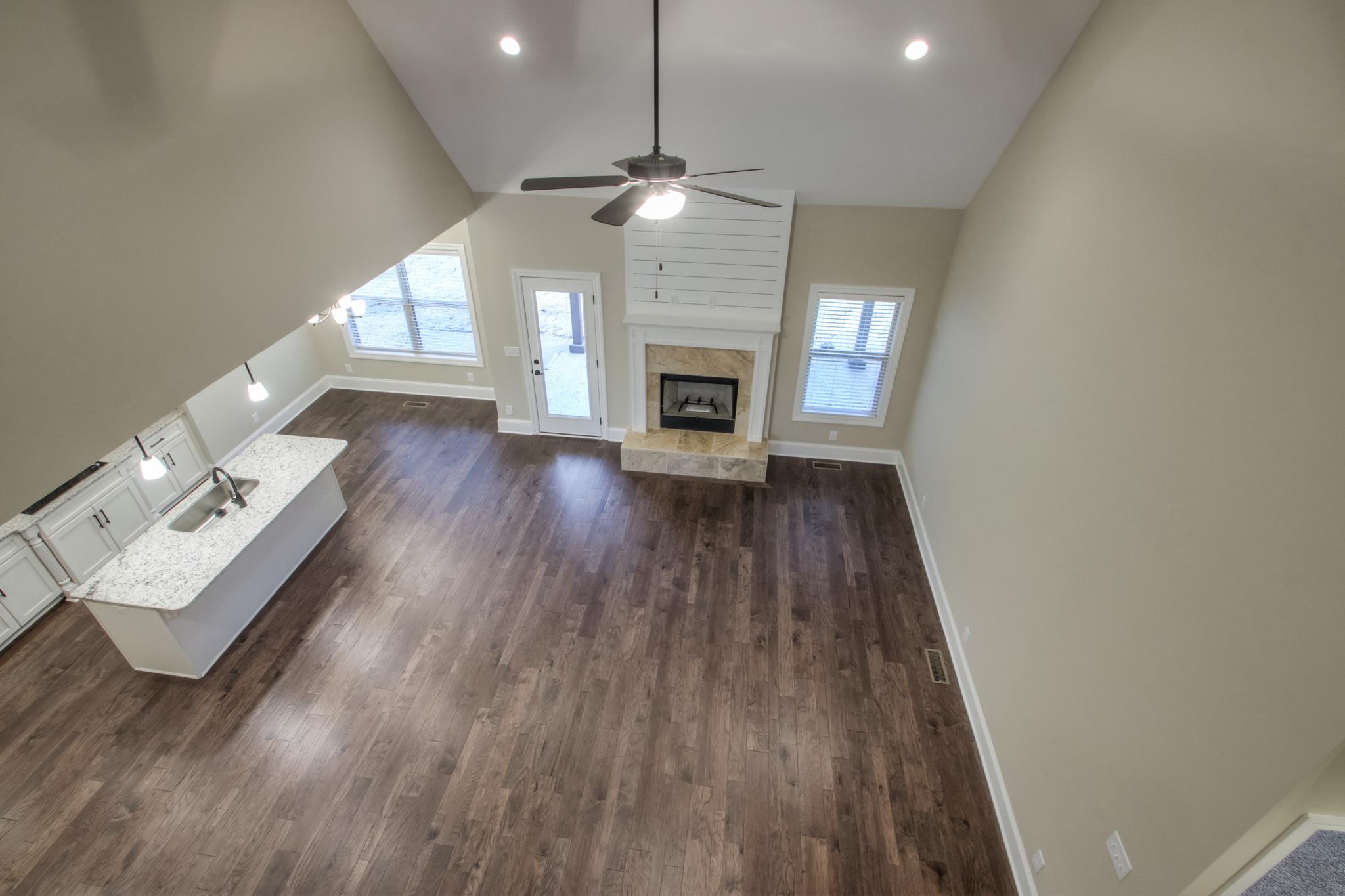 2305 Cairo Bend Road Lebanon, TN 37087 - Photo 22 of 30 a view of an empty room with wooden floor fireplace and a window