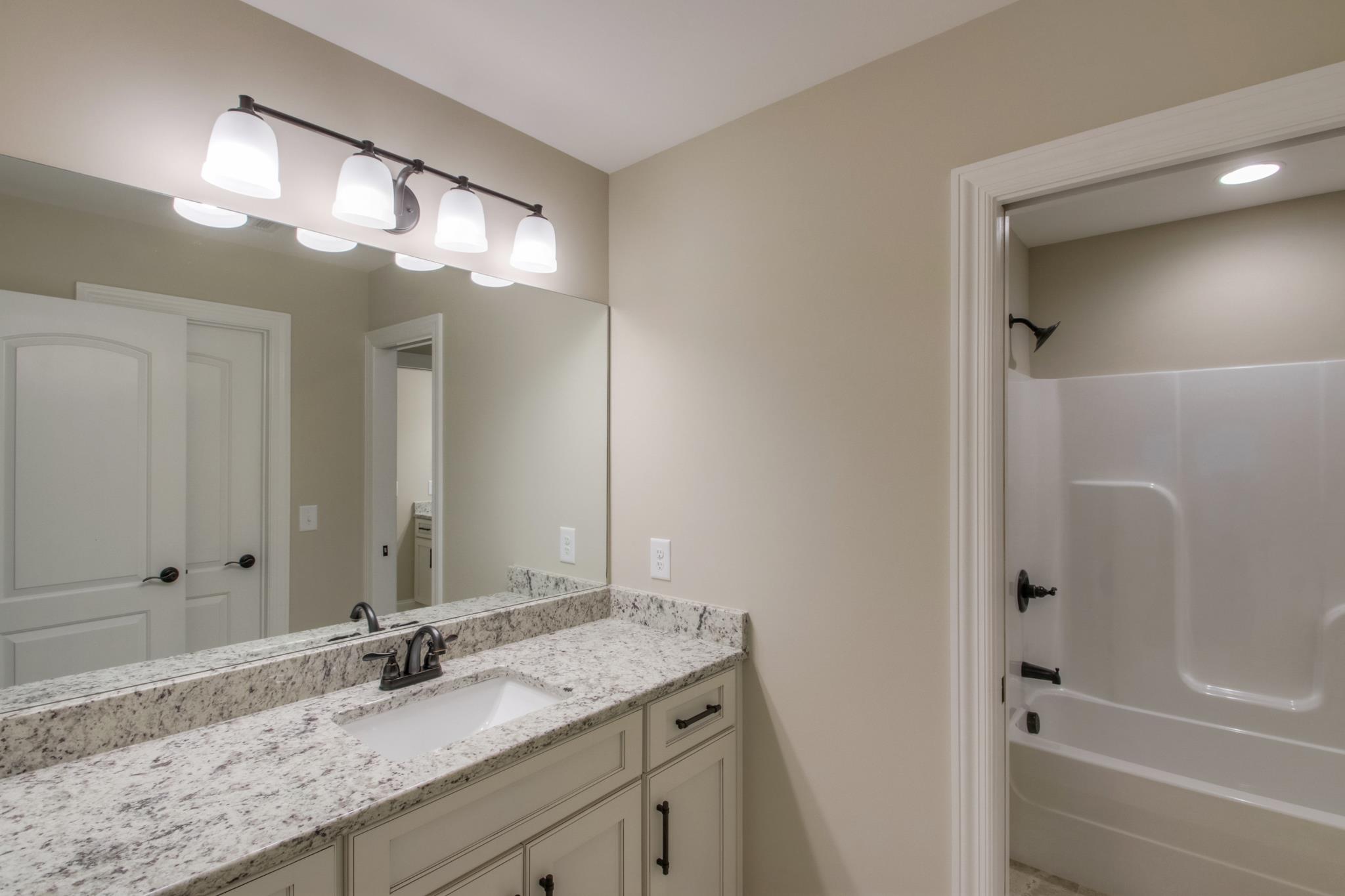 2305 Cairo Bend Road Lebanon, TN 37087 - Photo 23 of 30 a bathroom with a granite countertop sink and a mirror