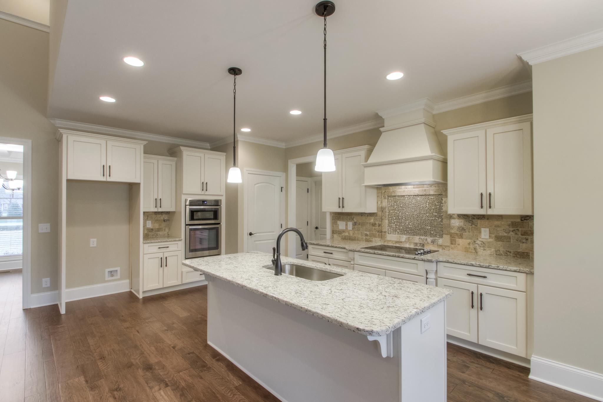 2305 Cairo Bend Road Lebanon, TN 37087 - Photo 10 of 30 a kitchen with stainless steel appliances granite countertop a sink a center island and a refrigerator