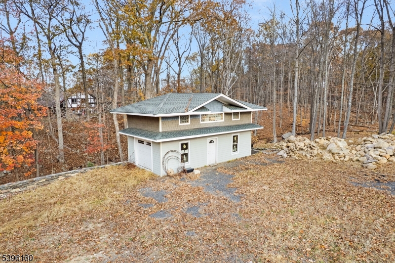 41 Kilroy Road Andover, NJ 07821 - Photo 4 of 11 a white house that has a tree in front of it