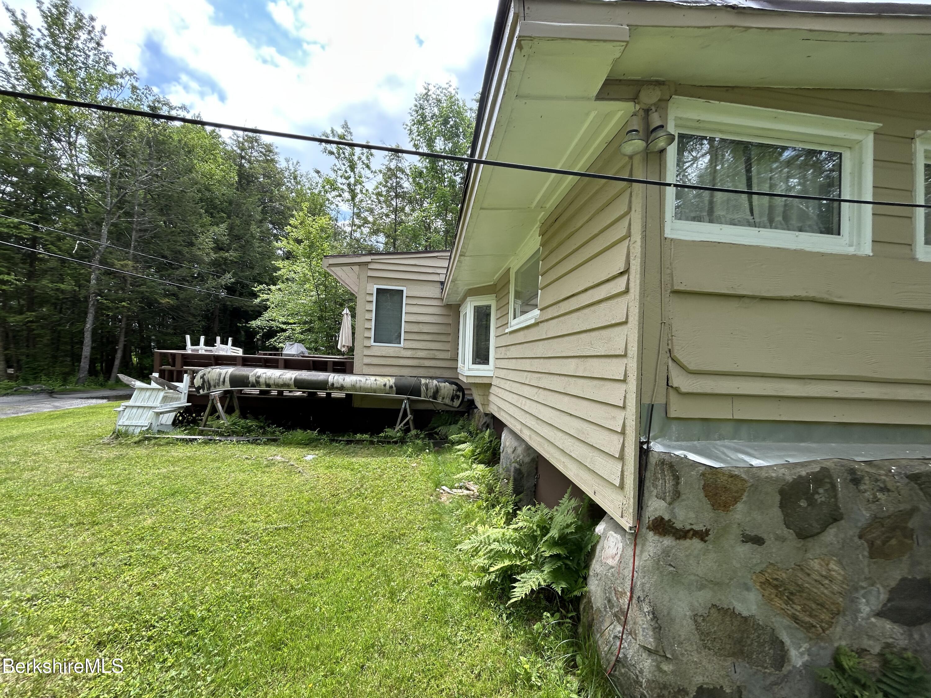 369 Pine Road Otis, MA 01029 - Photo 11 of 12 a view of a house with a backyard