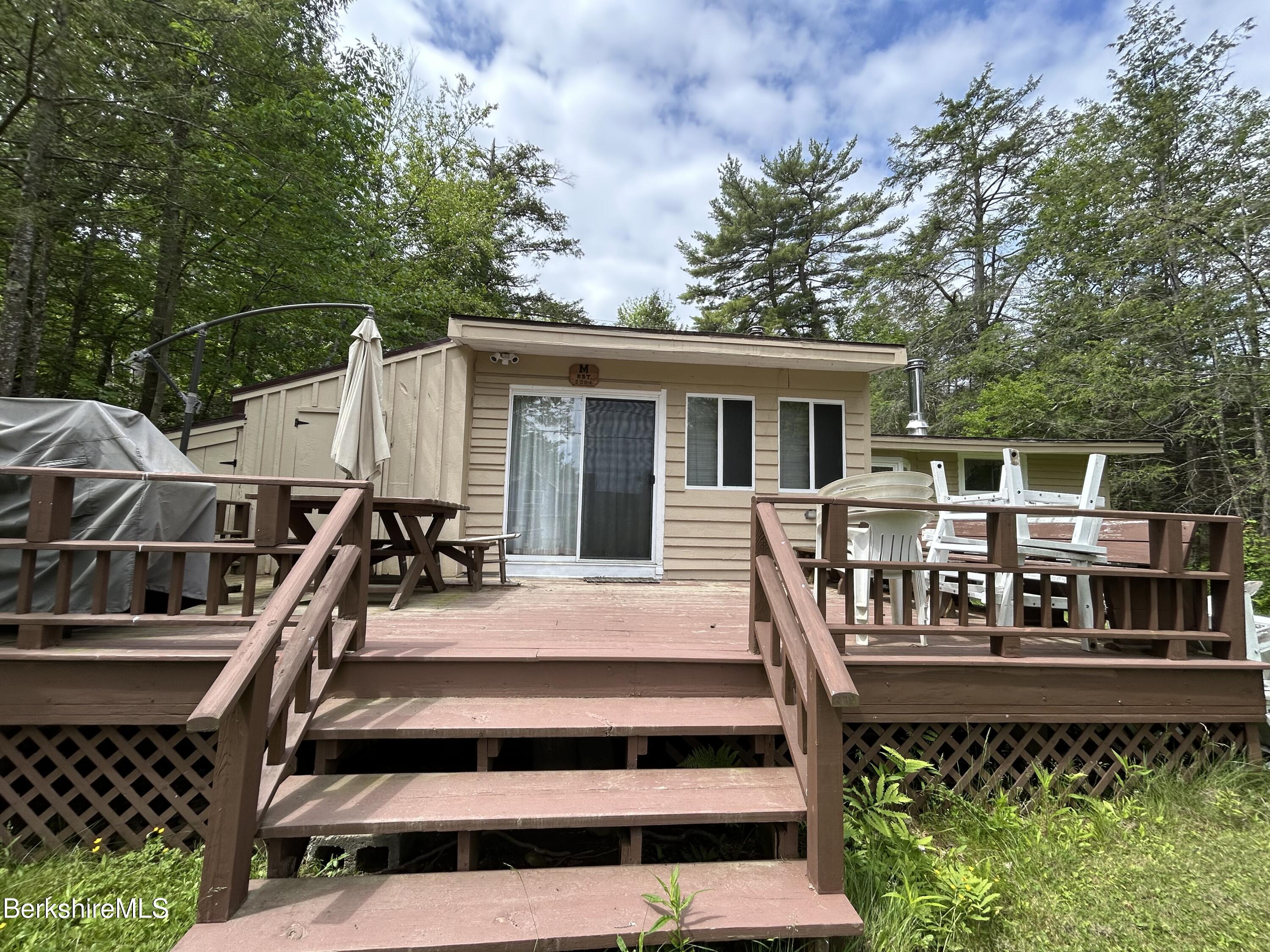 369 Pine Road Otis, MA 01029 - Photo 2 of 12 a view of a house with backyard and deck