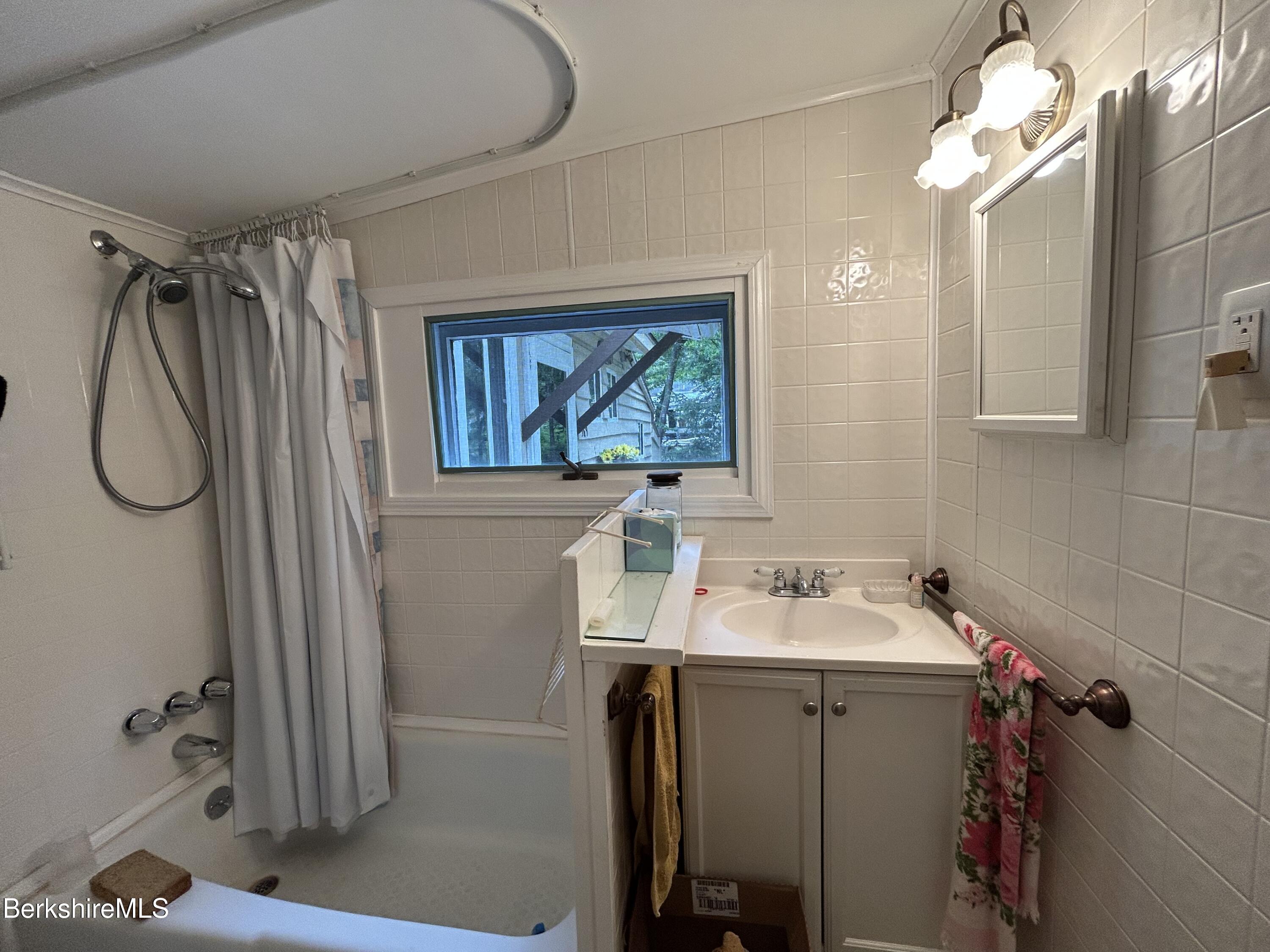 369 Pine Road Otis, MA 01029 - Photo 9 of 12 a bathroom with a sink mirror and vanity