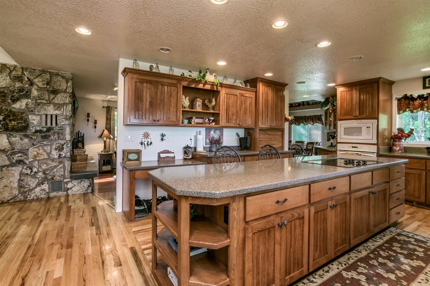 4110 Old Stage Road Central Point, OR 97502 - Photo 9 of 34 a kitchen with stainless steel appliances kitchen island granite countertop a sink and cabinets