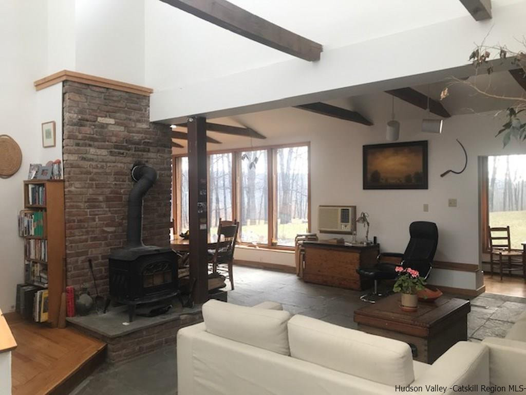 445 Plutarch Road Highland, NY 12528 - Photo 11 of 35 a living room with fireplace furniture and a flat screen tv