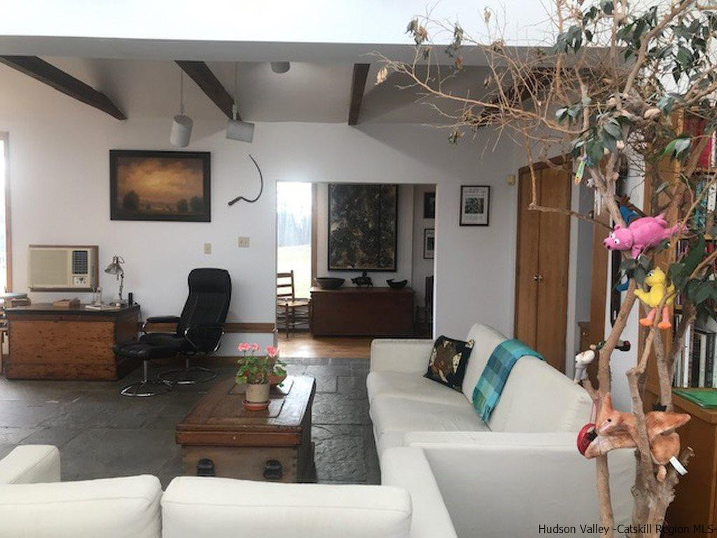 445 Plutarch Road Highland, NY 12528 - Photo 6 of 35 a living room with furniture and a flat screen tv