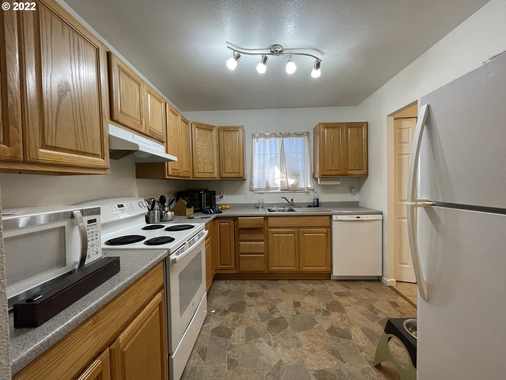868 Blanco Avenue Coos Bay, OR 97420 - Photo 16 of 29 a kitchen with a refrigerator sink stove and microwave