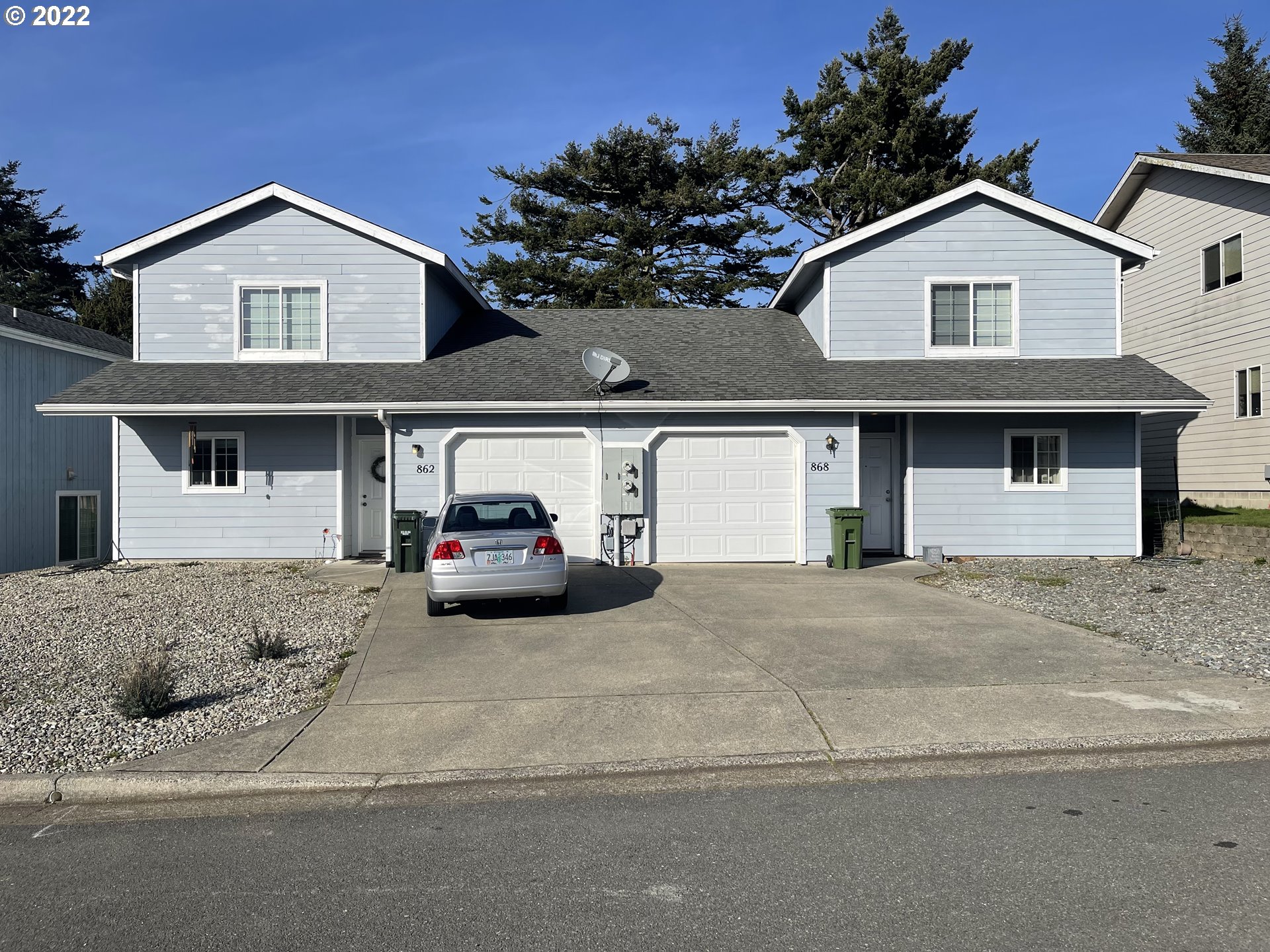 868 Blanco Avenue Coos Bay, OR 97420 - Photo 3 of 29 a front view of a house with a yard and garage