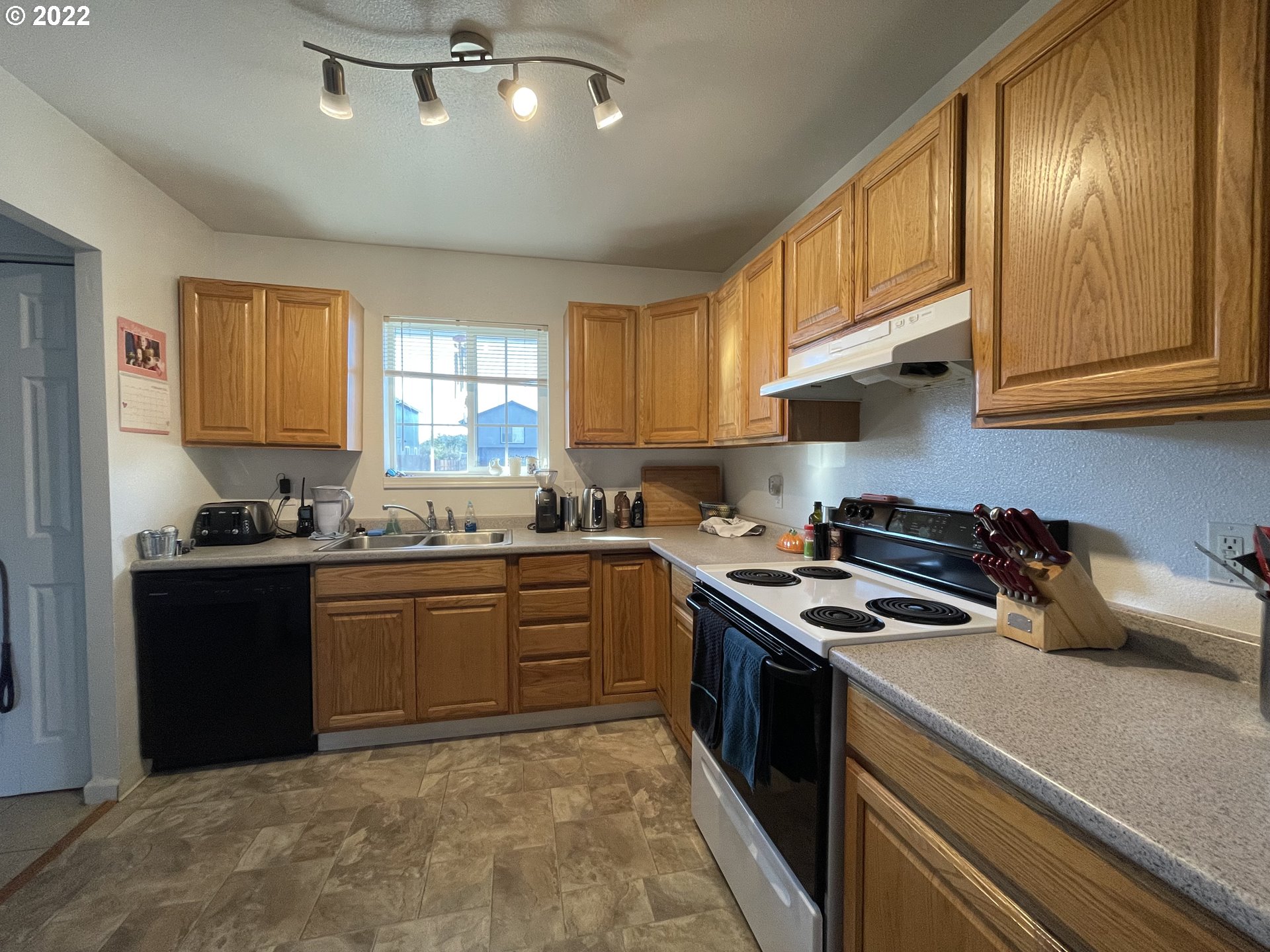 868 Blanco Avenue Coos Bay, OR 97420 - Photo 5 of 29 a kitchen with stainless steel appliances granite countertop a stove sink and cabinets