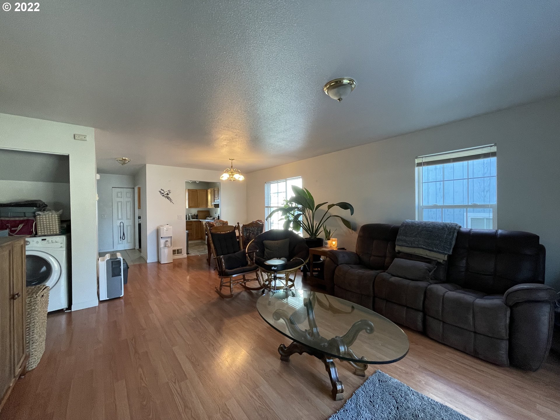 868 Blanco Avenue Coos Bay, OR 97420 - Photo 8 of 29 a living room with furniture a dining table and a refrigerator