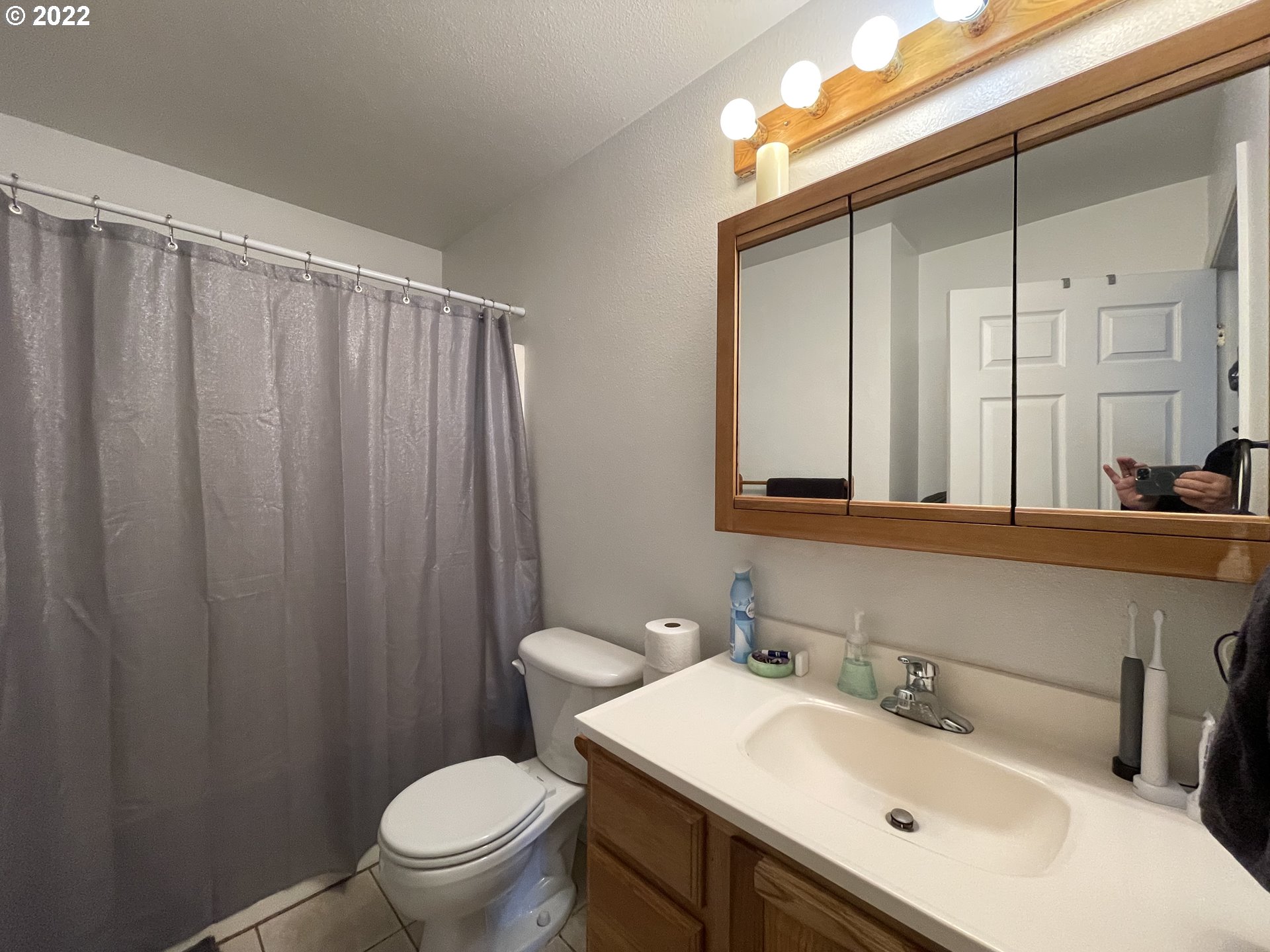 868 Blanco Avenue Coos Bay, OR 97420 - Photo 10 of 29 a bathroom with a sink vanity mirror and toilet