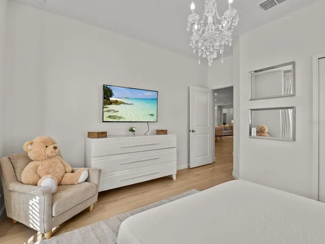 a bedroom with a bed and a television