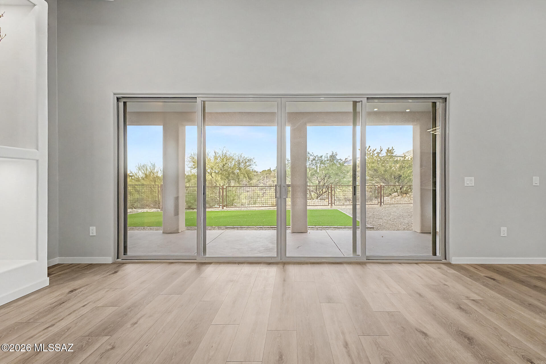2399 Della Roccia Court Tucson, AZ 85737 - Photo 14 of 34 a view of an empty room with wooden floor and a window