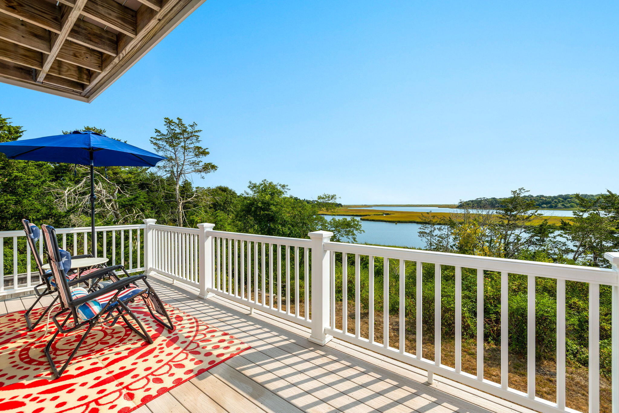 63 Briar Spring Road Orleans, MA 02653 - Photo 25 of 37 a view of a balcony with wooden floor and outdoor seating
