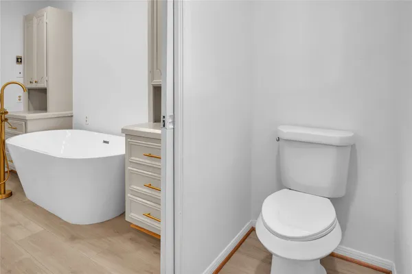 a bathroom with a double vanity sink a mirror and a bathtub