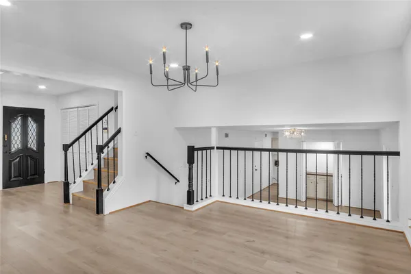 a large kitchen with kitchen island a island a sink a window and stainless steel appliances